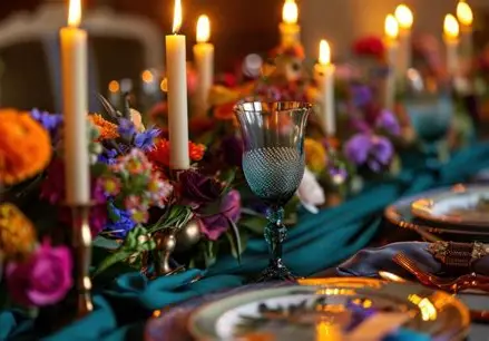 A Shabbat table: candles, flowers, places set